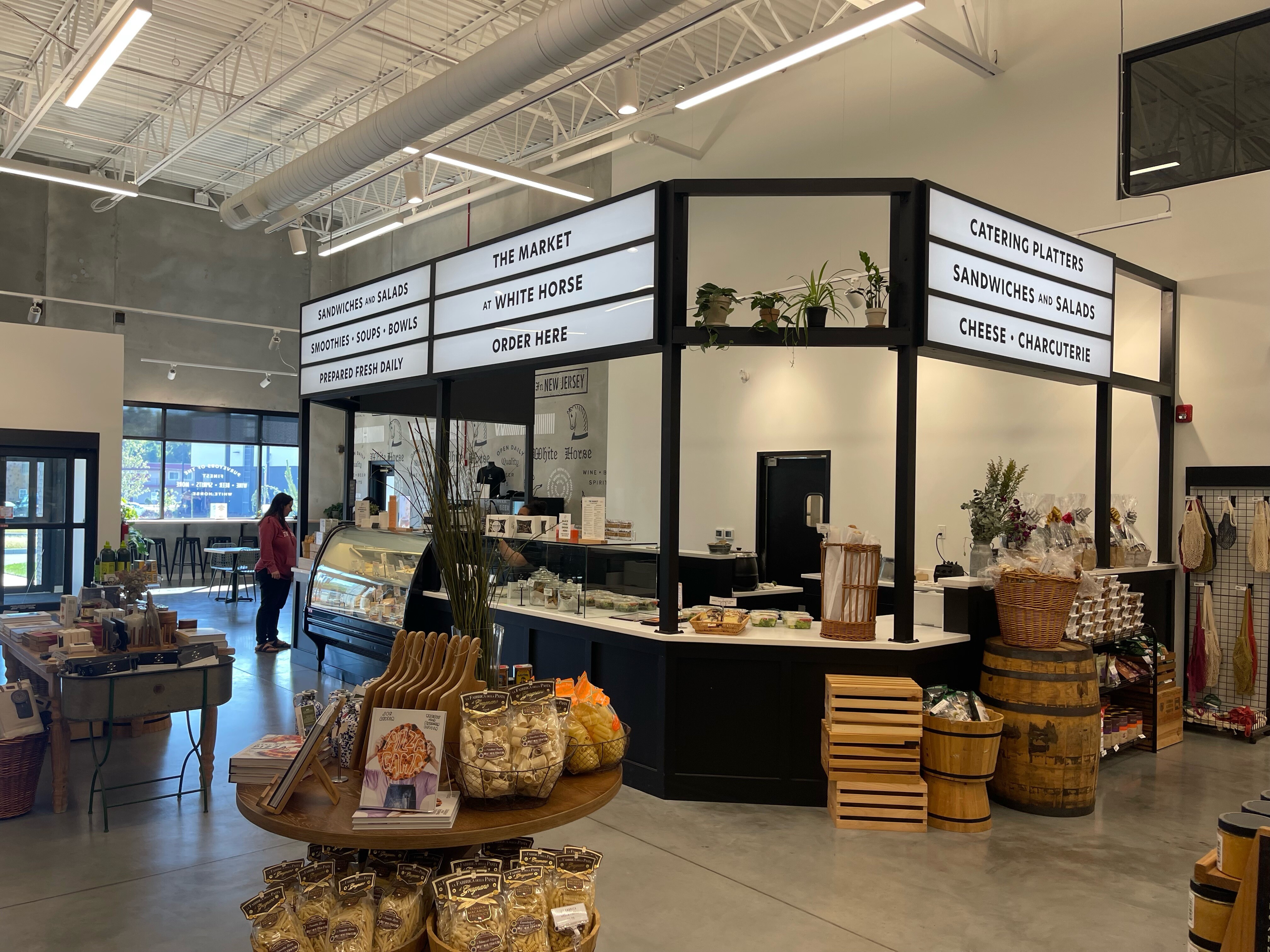 White Horse Wine and Spirits. Signage of menu above food stall inside market building. right side view